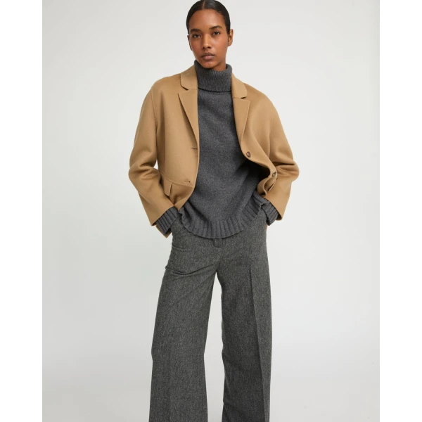 Woman wearing Yves Salomon shearling fur coat – luxury outerwear at Coveti