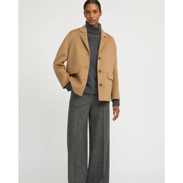 Woman wearing Yves Salomon shearling fur coat – luxury outerwear at Coveti