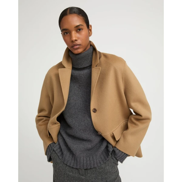Woman wearing Yves Salomon shearling fur coat – luxury outerwear at Coveti