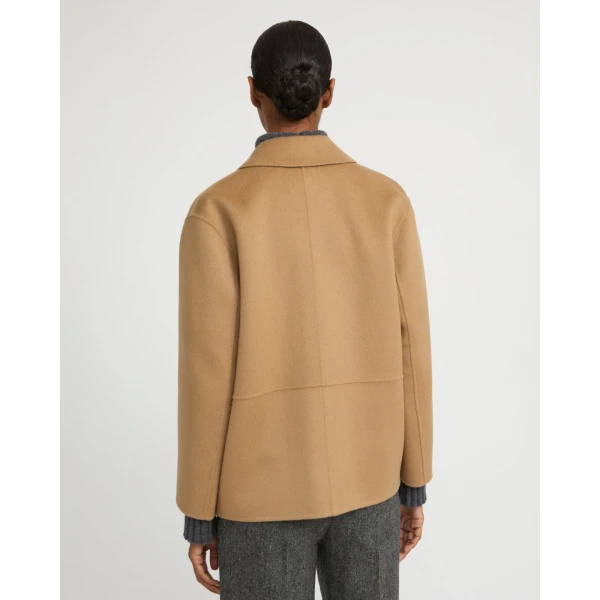 Woman wearing Yves Salomon shearling fur coat – luxury outerwear at Coveti
