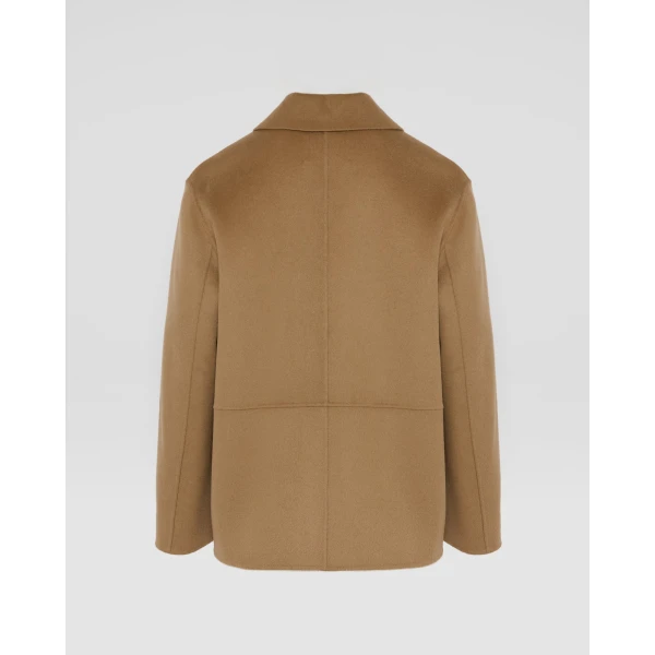 Woman wearing Yves Salomon shearling fur coat – luxury outerwear at Coveti