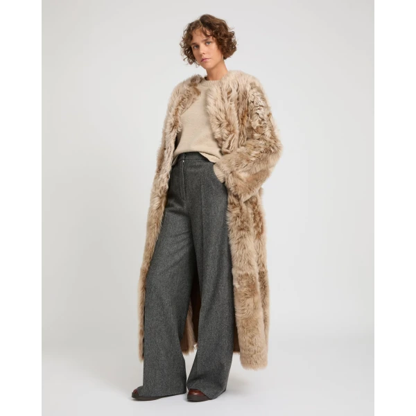 Woman wearing Yves Salomon shearling fur coat – luxury outerwear at Coveti