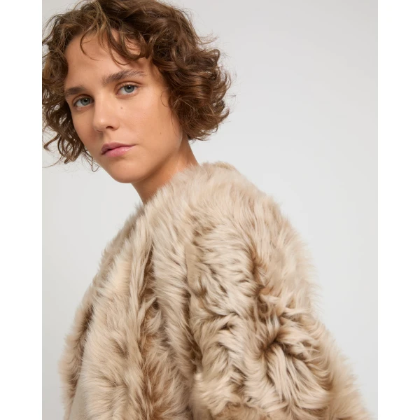 Woman wearing Yves Salomon shearling fur coat – luxury outerwear at Coveti