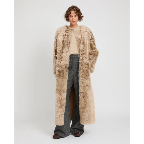 Woman wearing Yves Salomon shearling fur coat – luxury outerwear at Coveti