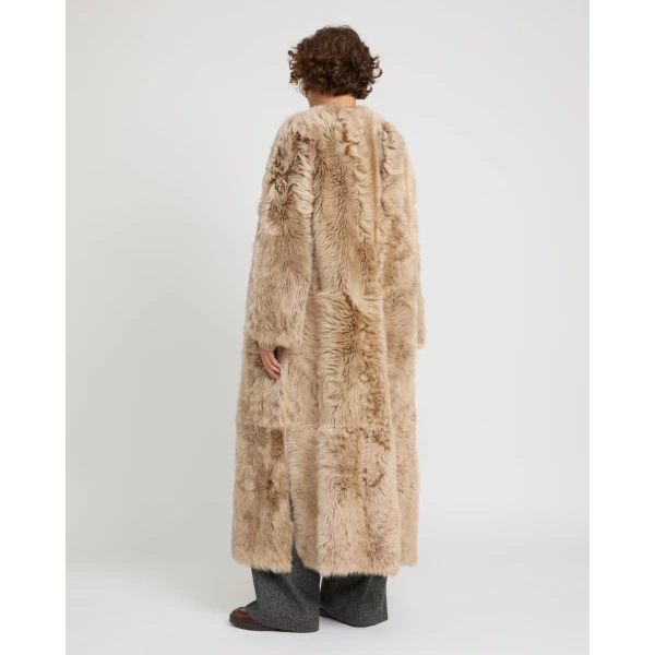 Woman wearing Yves Salomon shearling fur coat – luxury outerwear at Coveti
