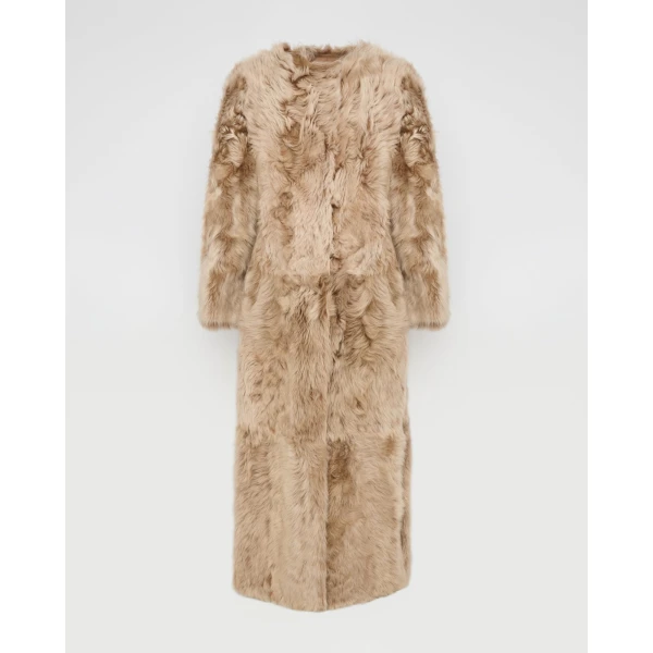 Woman wearing Yves Salomon shearling fur coat – luxury outerwear at Coveti
