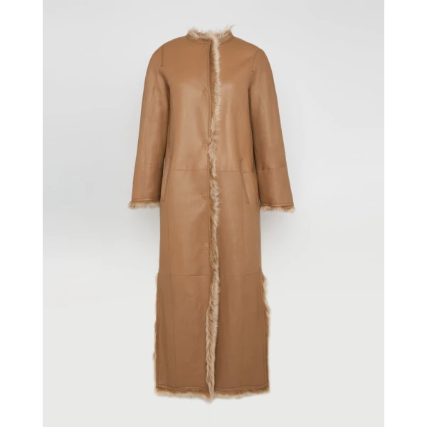 Woman wearing Yves Salomon shearling fur coat – luxury outerwear at Coveti