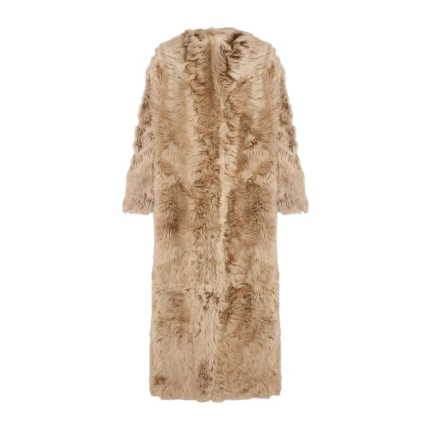 Woman wearing Yves Salomon shearling fur coat – luxury outerwear at Coveti