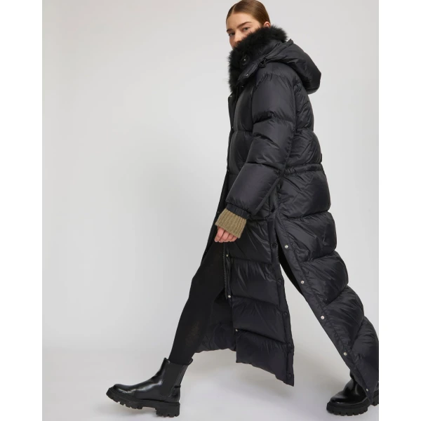 Woman wearing Yves Salomon shearling fur coat – luxury outerwear at Coveti