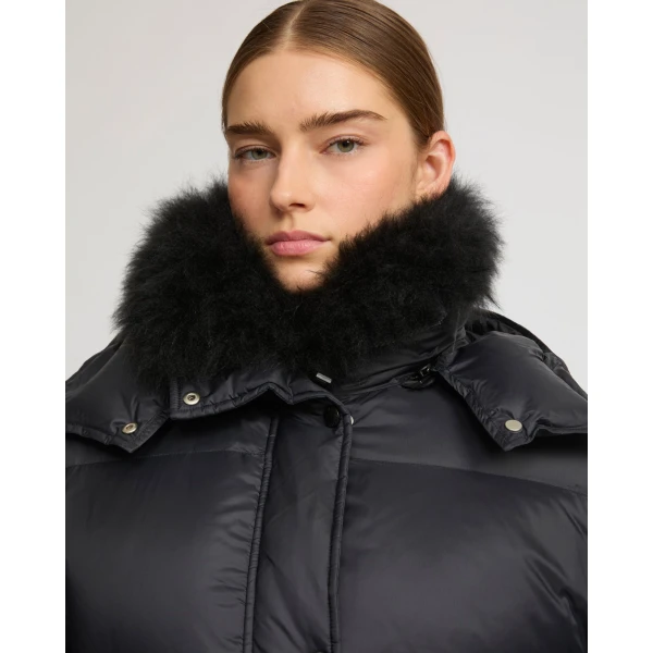 Woman wearing Yves Salomon shearling fur coat – luxury outerwear at Coveti