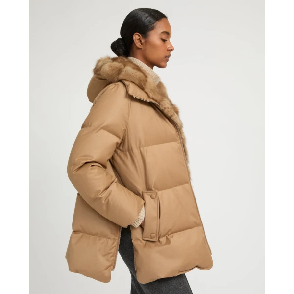 Woman wearing Yves Salomon shearling fur coat – luxury outerwear at Coveti