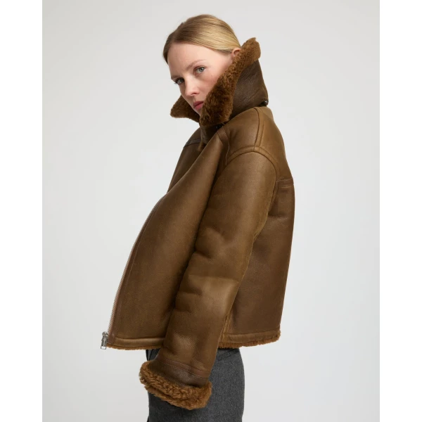Woman wearing Yves Salomon shearling fur coat – luxury outerwear at Coveti