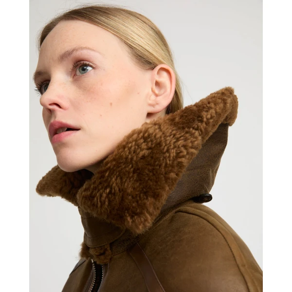 Woman wearing Yves Salomon shearling fur coat – luxury outerwear at Coveti