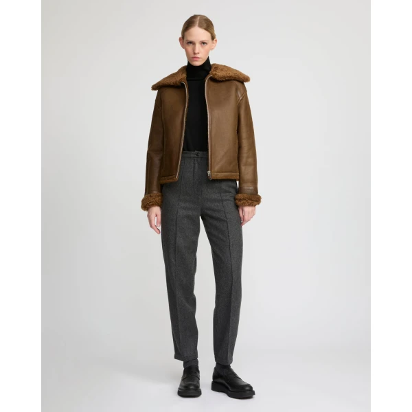Woman wearing Yves Salomon shearling fur coat – luxury outerwear at Coveti