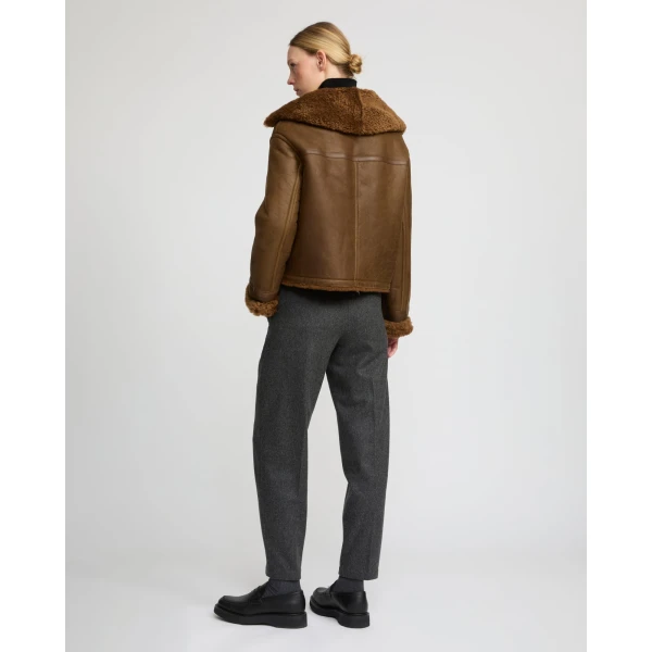 Woman wearing Yves Salomon shearling fur coat – luxury outerwear at Coveti