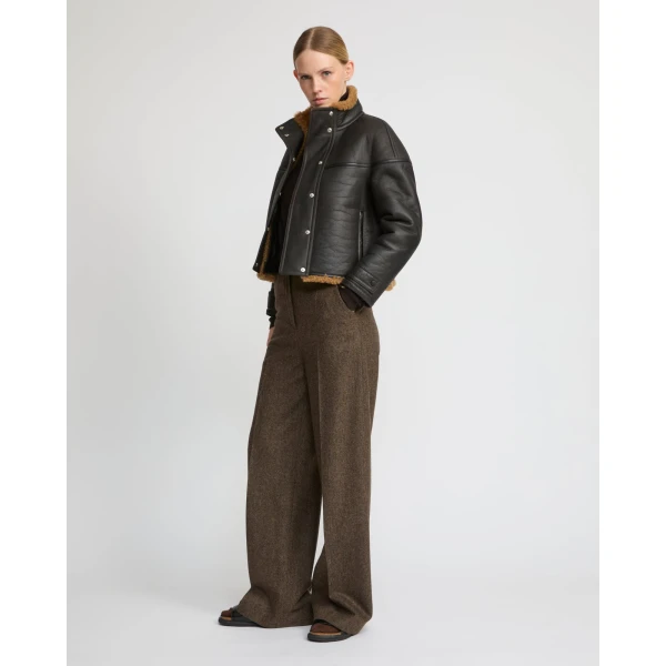 Woman wearing Yves Salomon shearling fur coat – luxury outerwear at Coveti