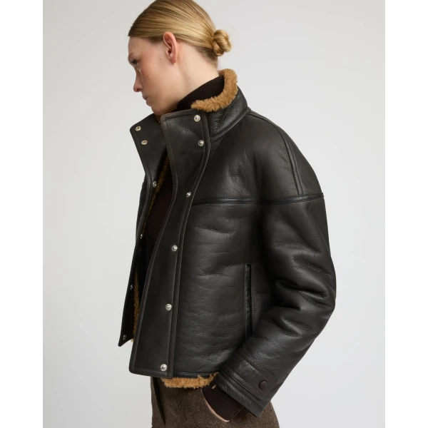 Woman wearing Yves Salomon shearling fur coat – luxury outerwear at Coveti