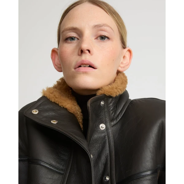 Woman wearing Yves Salomon shearling fur coat – luxury outerwear at Coveti