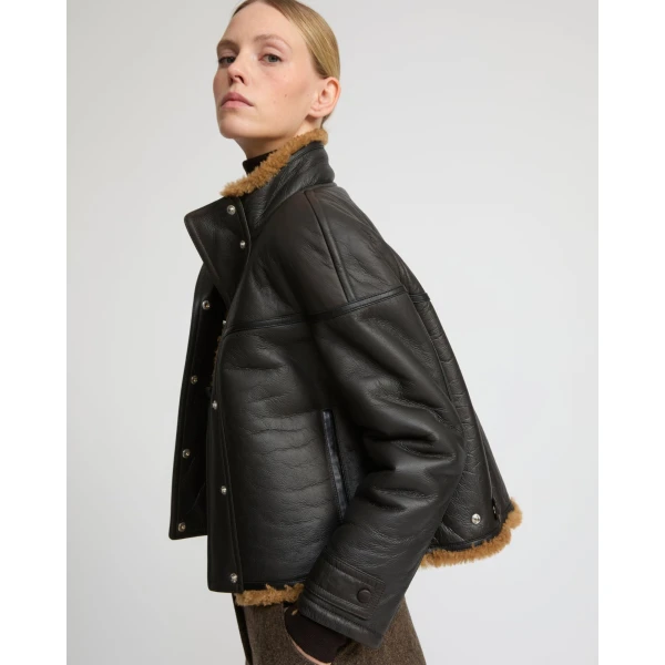 Woman wearing Yves Salomon shearling fur coat – luxury outerwear at Coveti