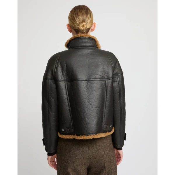 Woman wearing Yves Salomon shearling fur coat – luxury outerwear at Coveti
