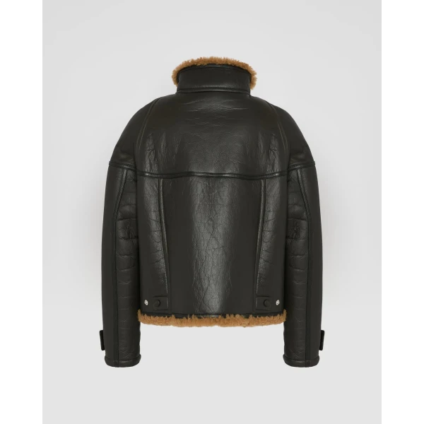 Woman wearing Yves Salomon shearling fur coat – luxury outerwear at Coveti