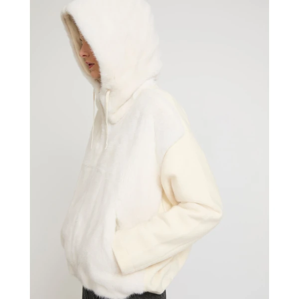 Woman wearing Yves Salomon shearling fur coat – luxury outerwear at Coveti