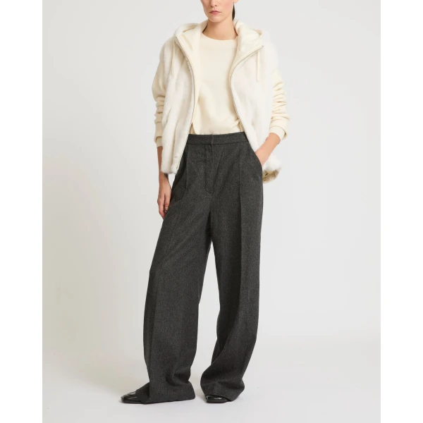 Woman wearing Yves Salomon shearling fur coat – luxury outerwear at Coveti