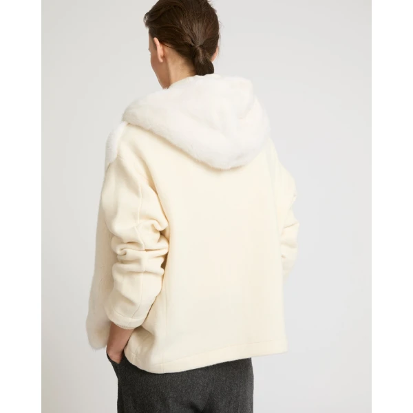 Woman wearing Yves Salomon shearling fur coat – luxury outerwear at Coveti