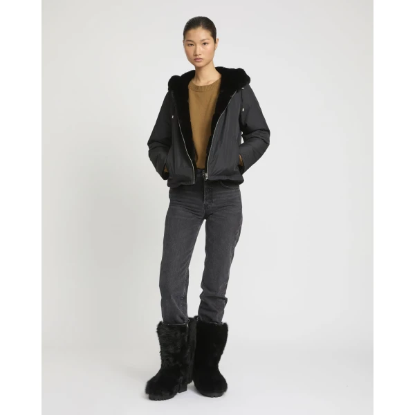 Woman wearing Yves Salomon shearling fur coat – luxury outerwear at Coveti