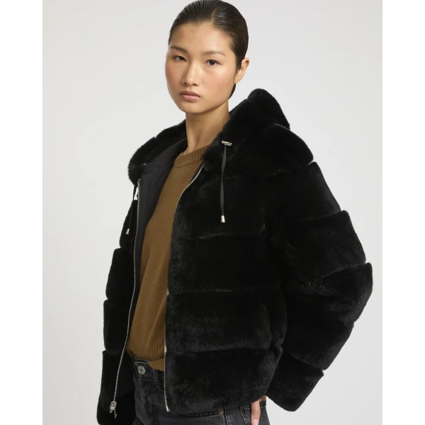 Woman wearing Yves Salomon shearling fur coat – luxury outerwear at Coveti