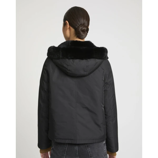 Woman wearing Yves Salomon shearling fur coat – luxury outerwear at Coveti