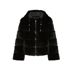Woman wearing Yves Salomon shearling fur coat – luxury outerwear at Coveti
