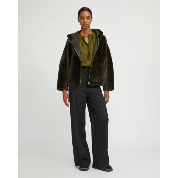 Woman wearing Yves Salomon shearling fur coat – luxury outerwear at Coveti