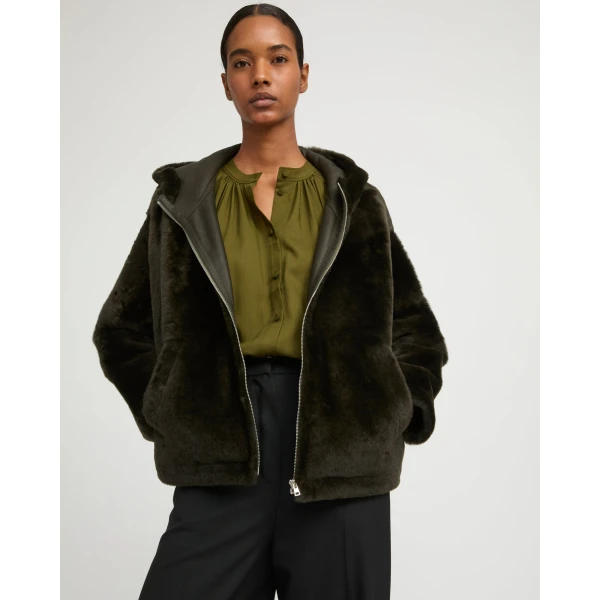 Woman wearing Yves Salomon shearling fur coat – luxury outerwear at Coveti