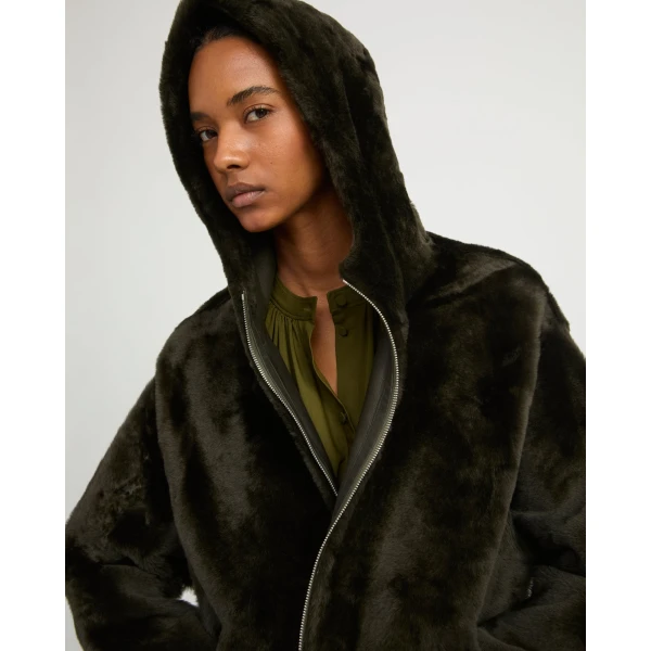 Woman wearing Yves Salomon shearling fur coat – luxury outerwear at Coveti