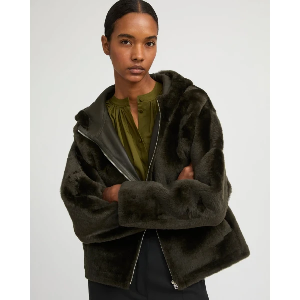 Woman wearing Yves Salomon shearling fur coat – luxury outerwear at Coveti