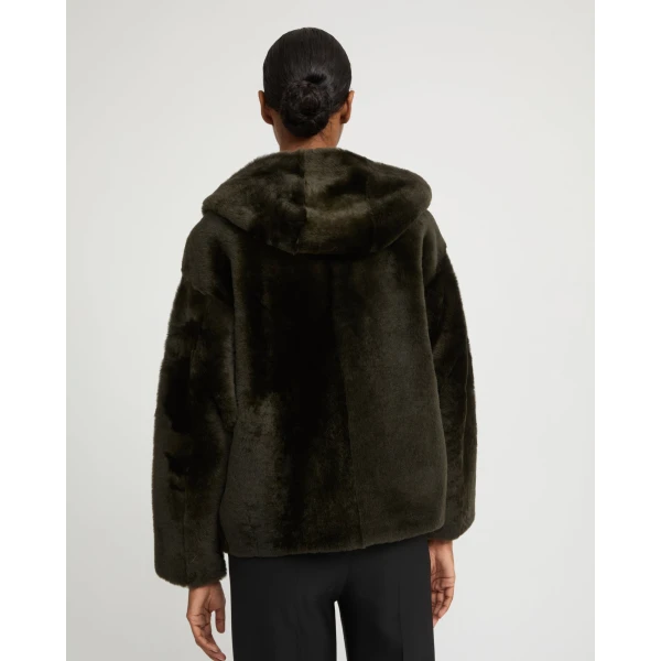Woman wearing Yves Salomon shearling fur coat – luxury outerwear at Coveti
