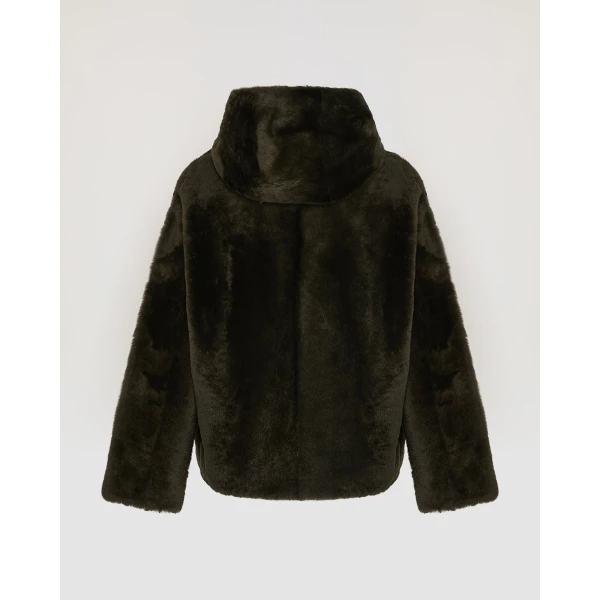 Woman wearing Yves Salomon shearling fur coat – luxury outerwear at Coveti