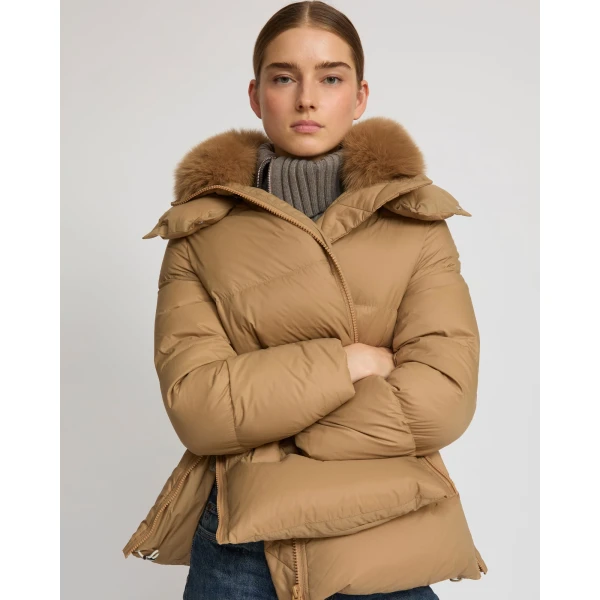 Woman wearing Yves Salomon shearling fur coat – luxury outerwear at Coveti