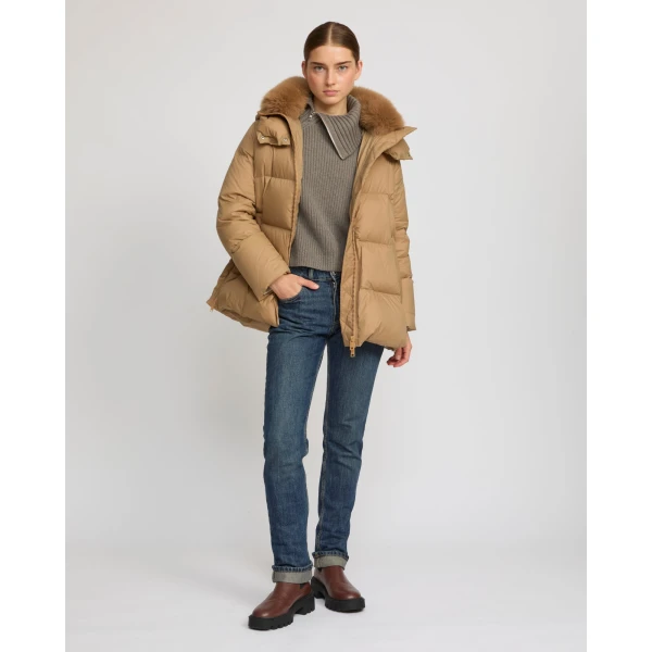Woman wearing Yves Salomon shearling fur coat – luxury outerwear at Coveti