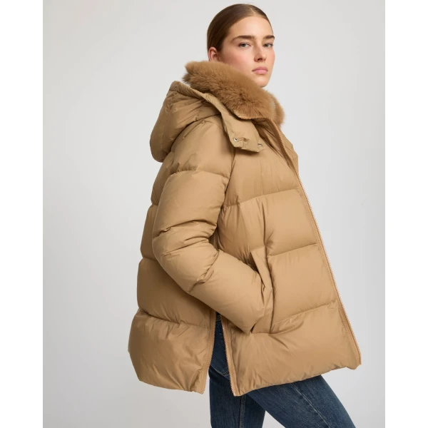 Woman wearing Yves Salomon shearling fur coat – luxury outerwear at Coveti
