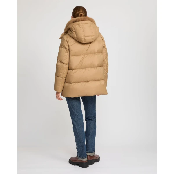 Woman wearing Yves Salomon shearling fur coat – luxury outerwear at Coveti