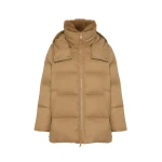 Woman wearing Yves Salomon shearling fur coat – luxury outerwear at Coveti