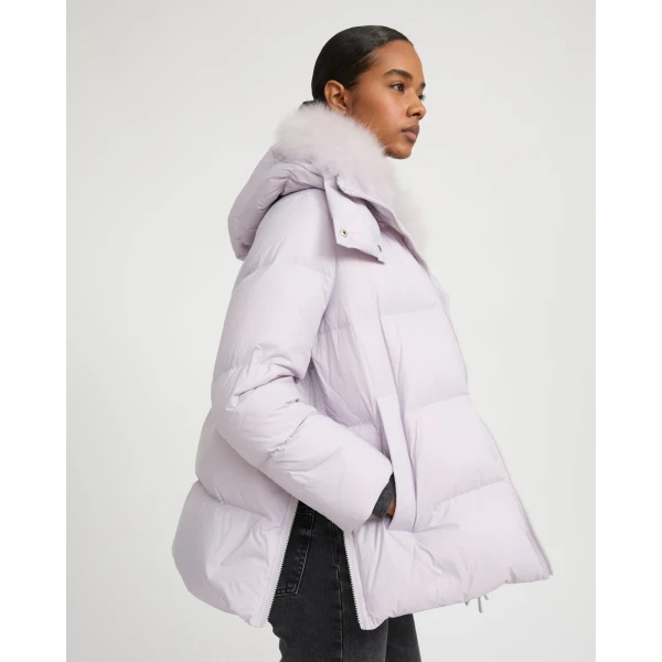 Woman wearing Yves Salomon shearling fur coat – luxury outerwear at Coveti