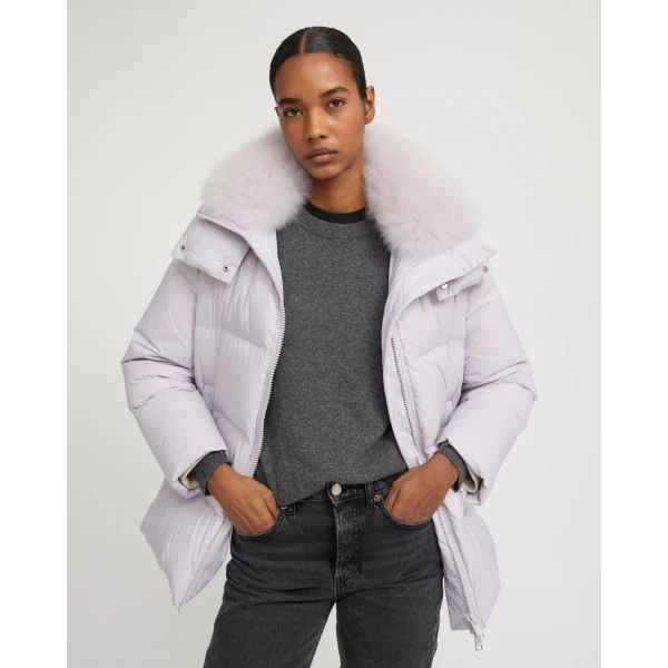 Woman wearing Yves Salomon shearling fur coat – luxury outerwear at Coveti