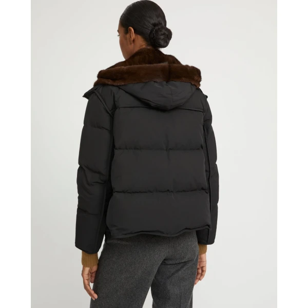 Woman wearing Yves Salomon shearling fur coat – luxury outerwear at Coveti