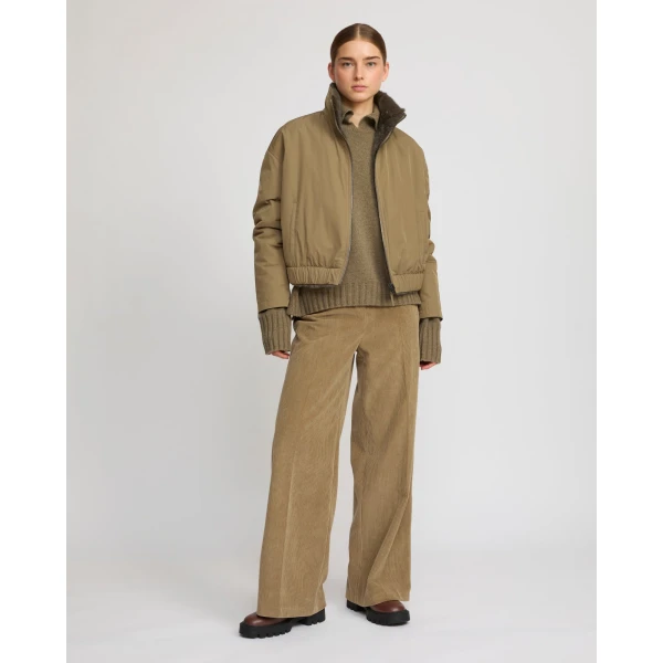 Woman wearing Yves Salomon shearling fur coat – luxury outerwear at Coveti