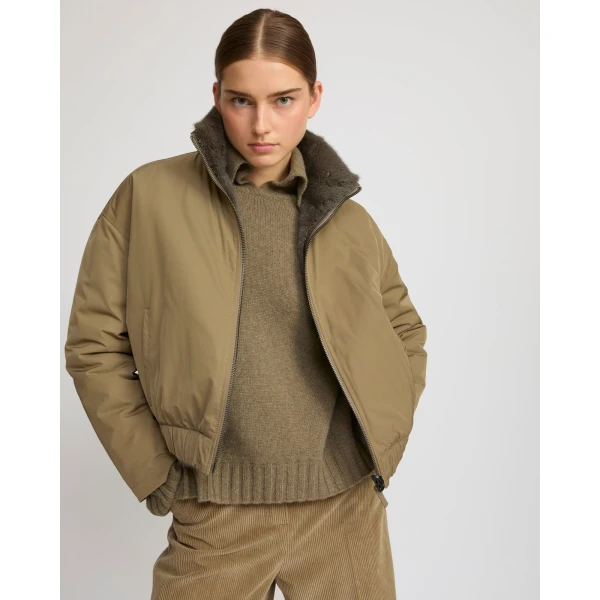 Woman wearing Yves Salomon shearling fur coat – luxury outerwear at Coveti