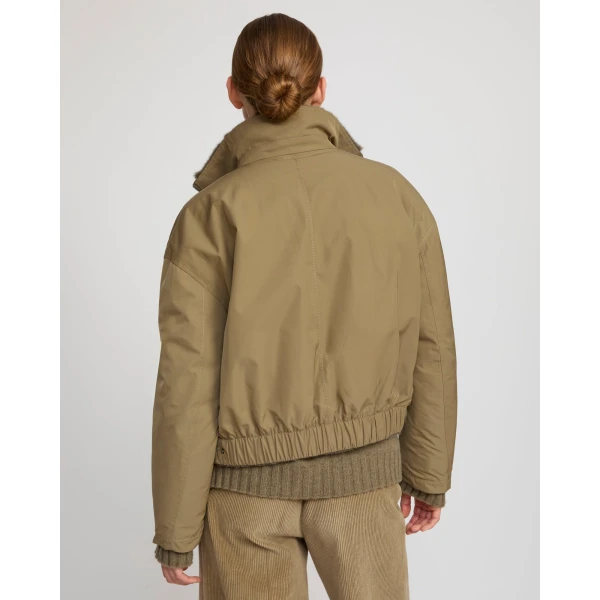 Woman wearing Yves Salomon shearling fur coat – luxury outerwear at Coveti