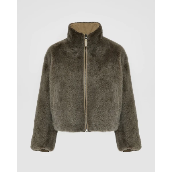 Woman wearing Yves Salomon shearling fur coat – luxury outerwear at Coveti